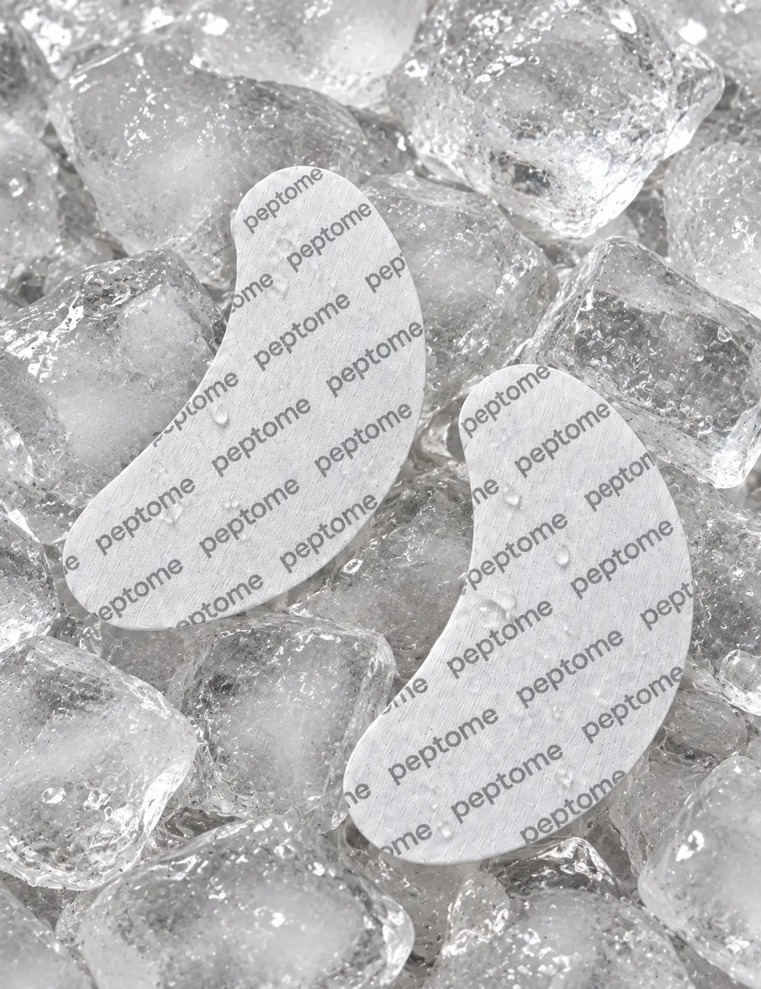 Two peptome-printed hydrogel eye patches resting on clear ice
